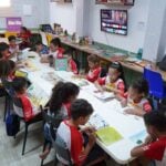 Children engaged in reading at a community library in Glória do Goitá, Brazil.