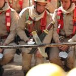 Brazilian firefighters participate in a training exercise with machetes in Mato Grosso, Brazil.